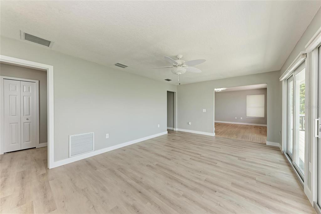 893 North Shore Drive Anna Maria, FL 34216 - Photo 41 of 62 a view of an empty room with wooden floor and window