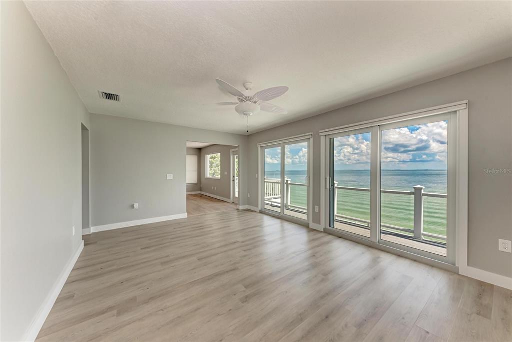 893 North Shore Drive Anna Maria, FL 34216 - Photo 42 of 62 wooden floor in an empty room with a window