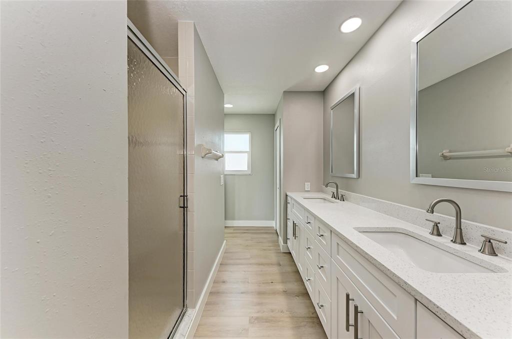 893 North Shore Drive Anna Maria, FL 34216 - Photo 48 of 62 a large white bathroom with sink and mirror