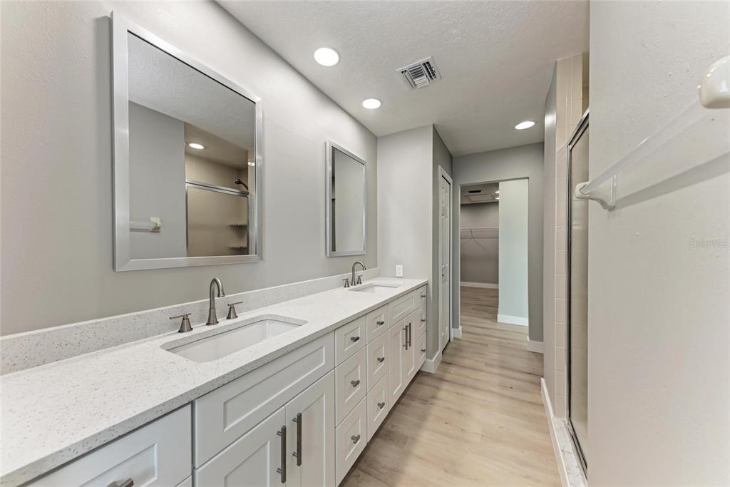 893 North Shore Drive Anna Maria, FL 34216 - Photo 49 of 62 a bathroom with a double vanity sink and a mirror