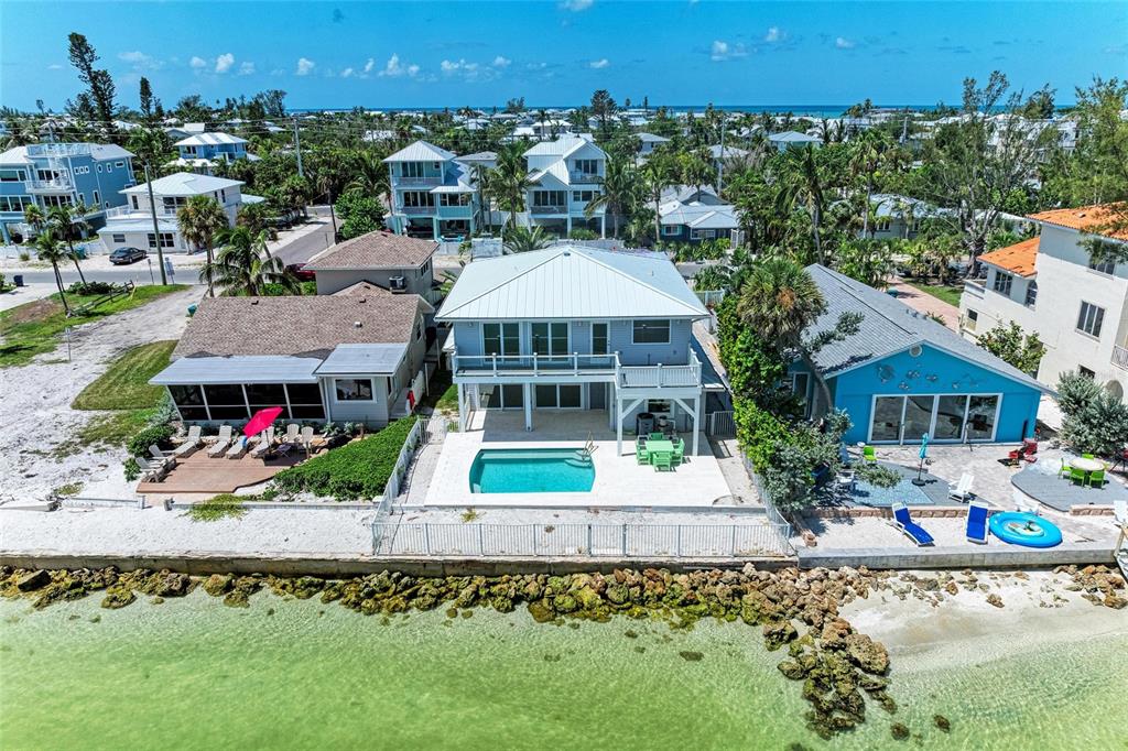 893 North Shore Drive Anna Maria, FL 34216 - Photo 55 of 62 an aerial view of a house with a garden and a yard