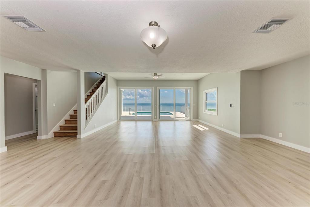 893 North Shore Drive Anna Maria, FL 34216 - Photo 8 of 62 a view of an empty room with wooden floor and a window