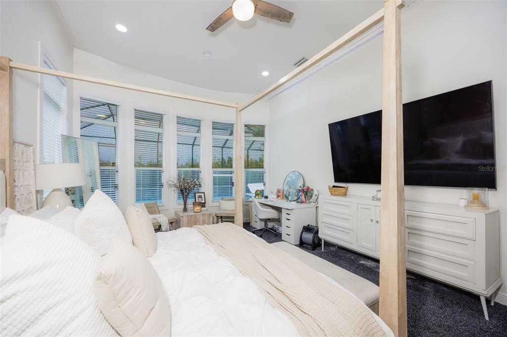 14006 Quarry Lake Road Lithia, FL 33547 - Photo 16 of 50 a large bedroom with a bed and flat tv screen on dresser