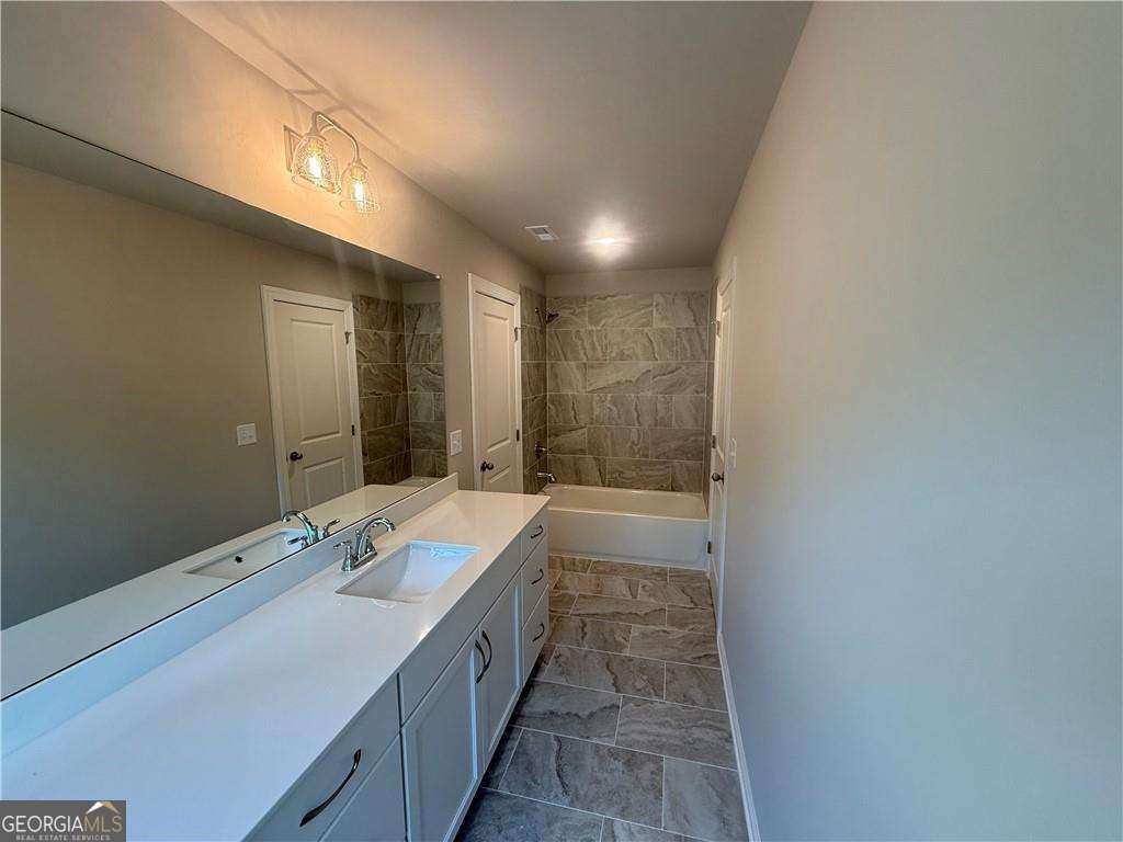 352 Lakeside Drive Canton, GA 30115 - Photo 15 of 16 a bathroom with a tub sink and mirror