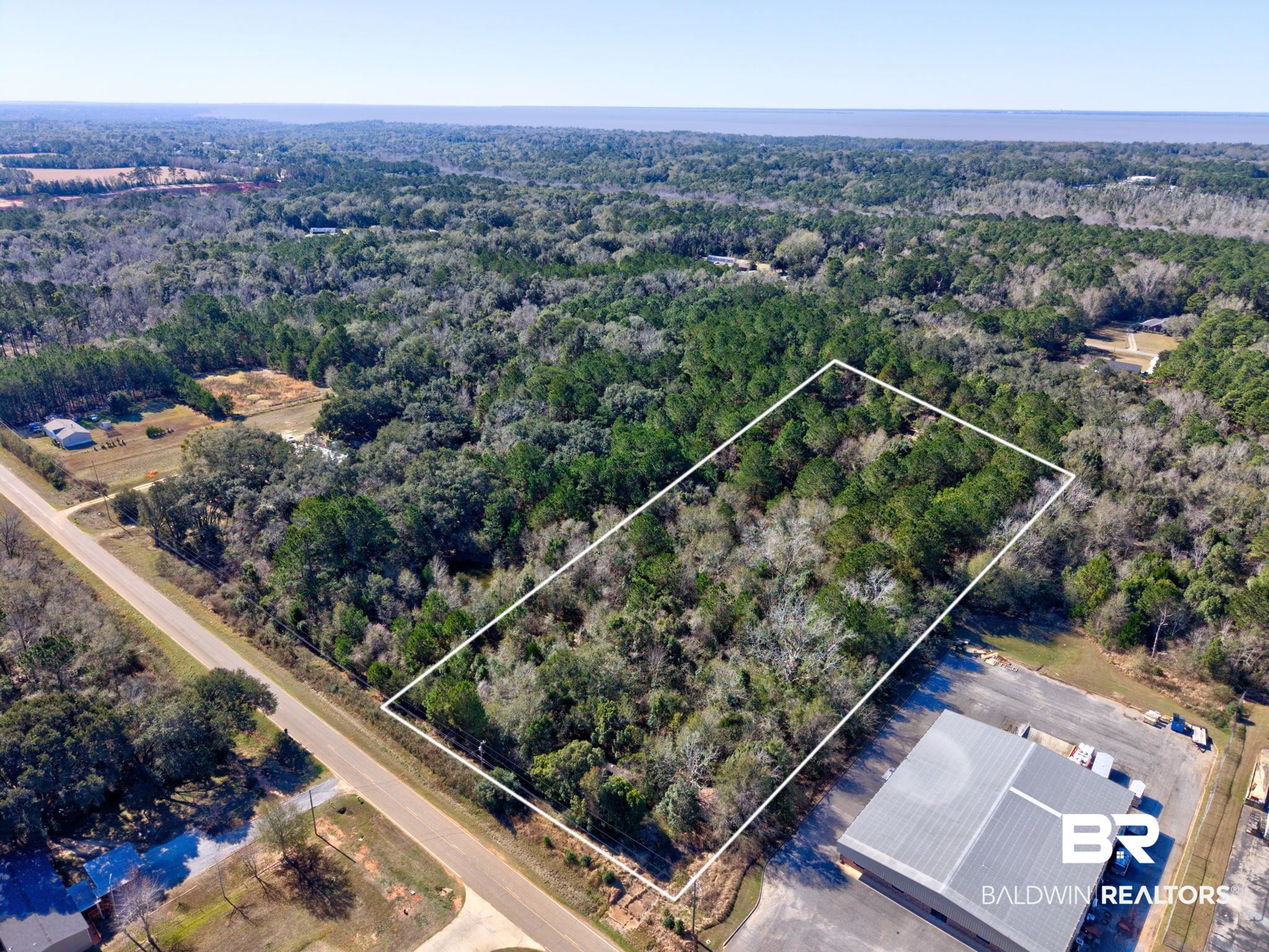 25280 Friendship Road Daphne, AL 36526 - Photo 1 of 34 Aerial view of property's location featuring a forest and property parcel outlined