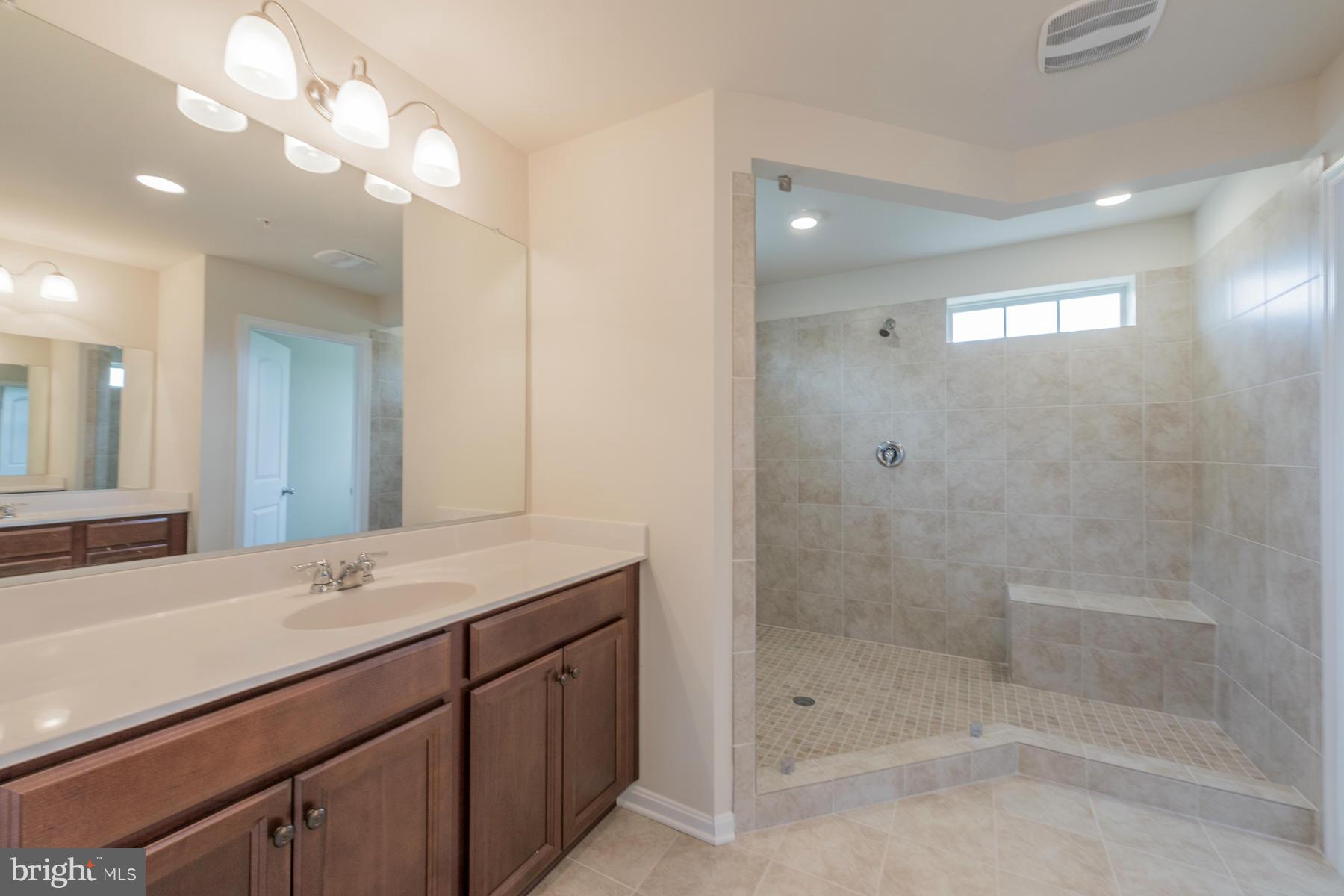 4336 Chapel Road Perry Hall, MD 21128 - Photo 22 of 30 a bathroom with a shower sink and mirror