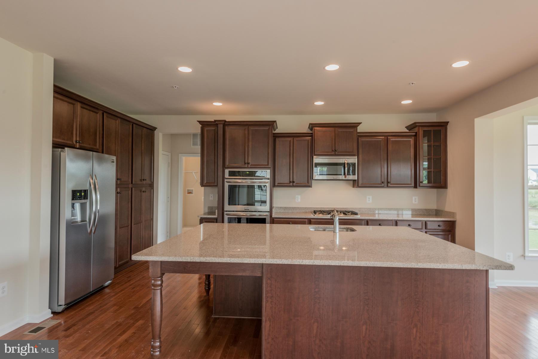 4336 Chapel Road Perry Hall, MD 21128 - Photo 4 of 30 a kitchen with kitchen island a sink stainless steel appliances and cabinets