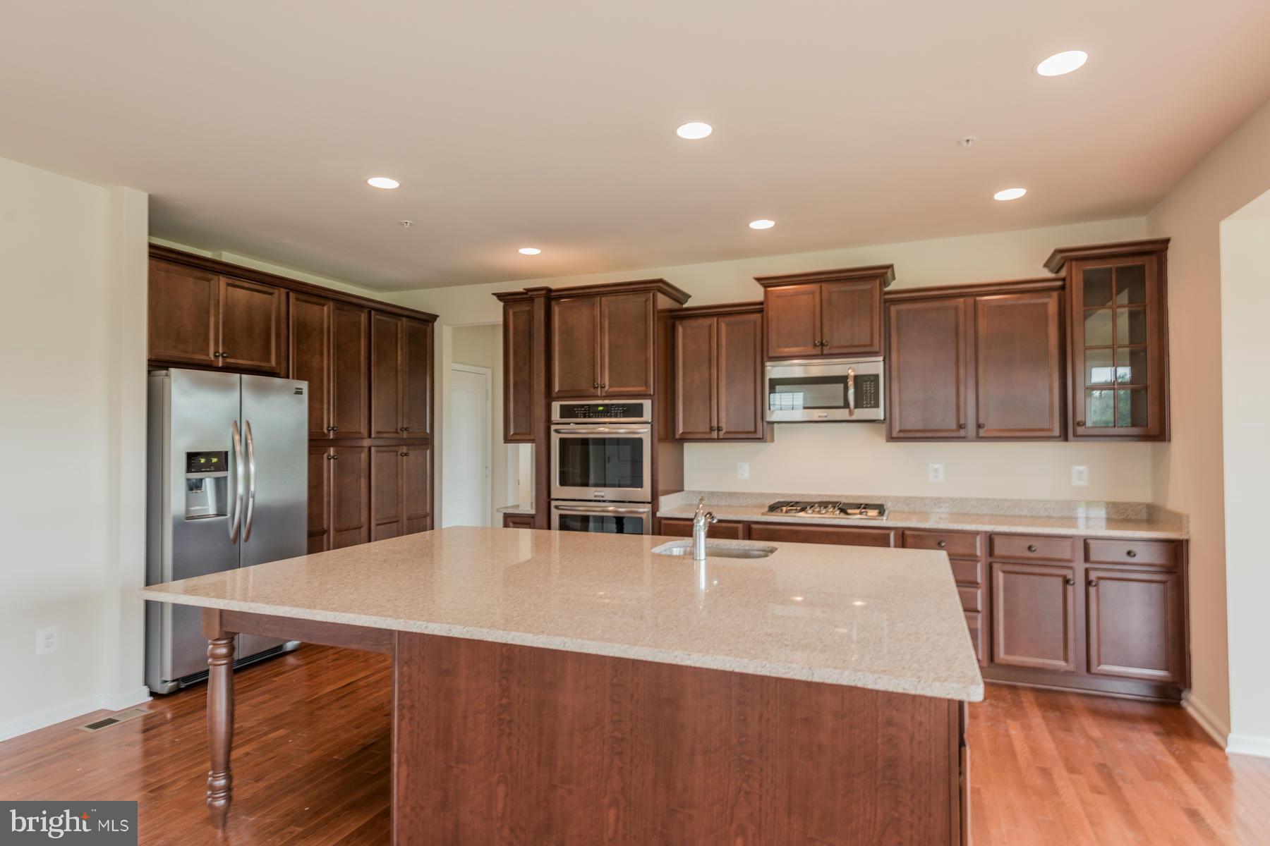4336 Chapel Road Perry Hall, MD 21128 - Photo 5 of 30 a kitchen with kitchen island a sink stove and refrigerator