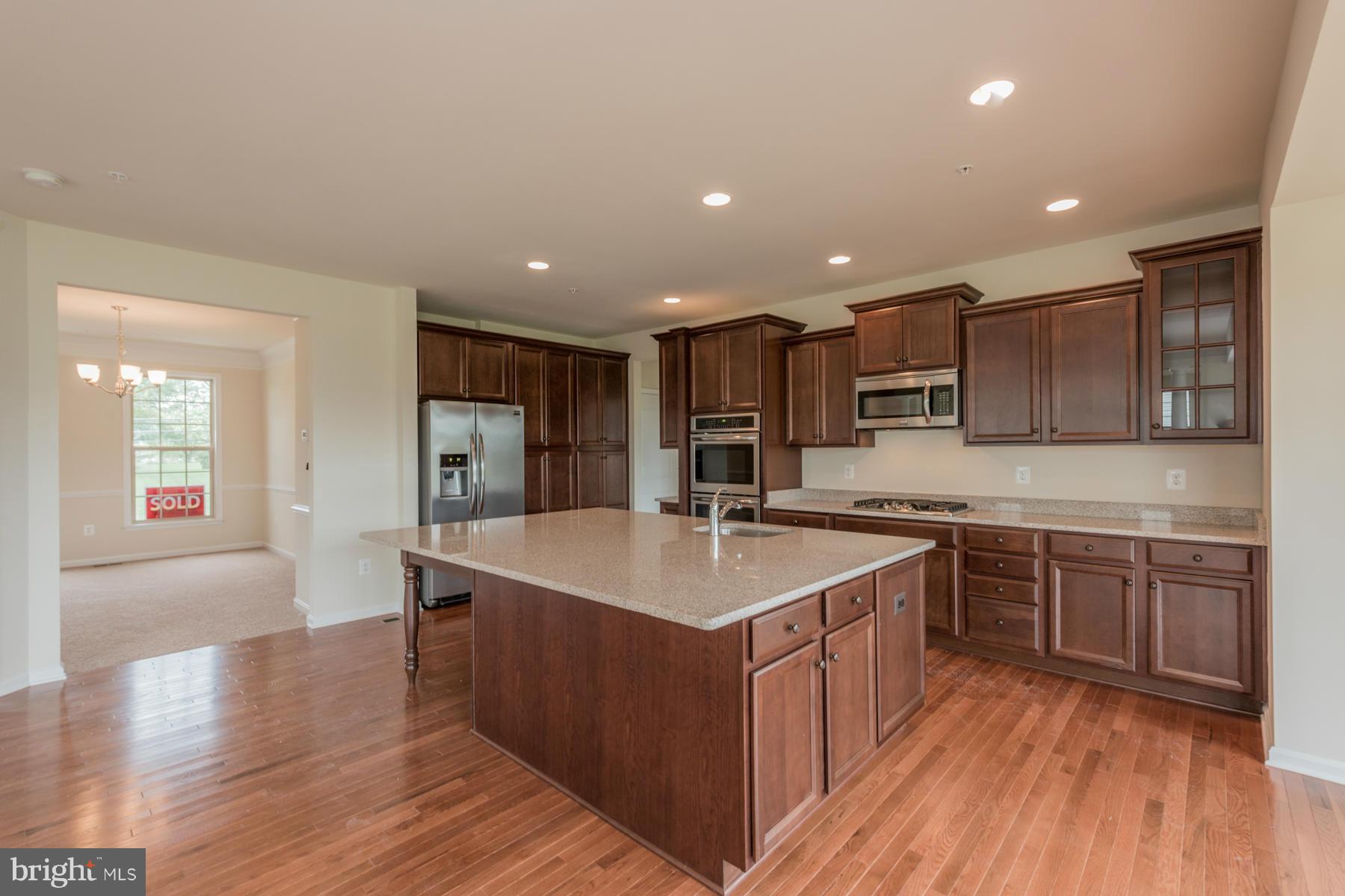 4336 Chapel Road Perry Hall, MD 21128 - Photo 6 of 30 a large kitchen with stainless steel appliances a sink and cabinets