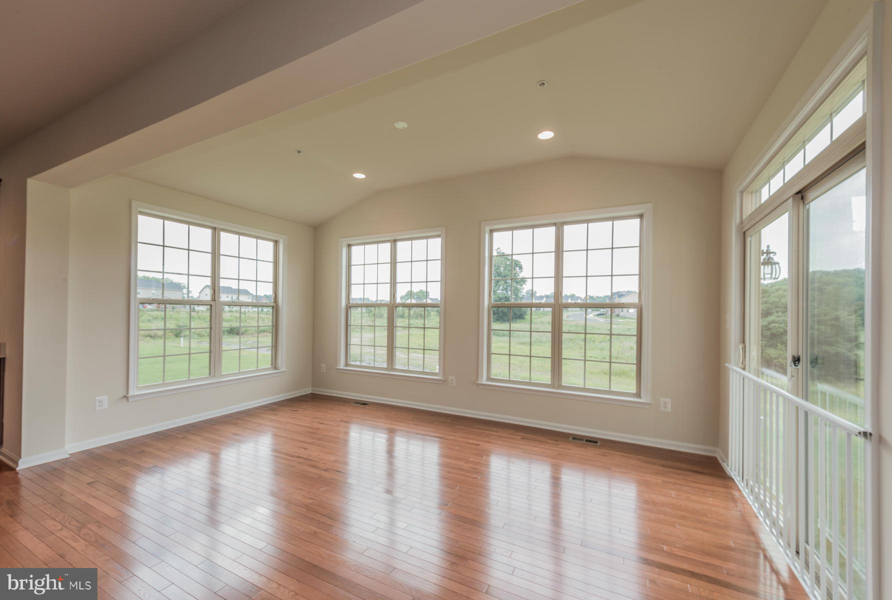 4336 Chapel Road Perry Hall, MD 21128 - Photo 9 of 30 a view of an empty room with wooden floor and a window