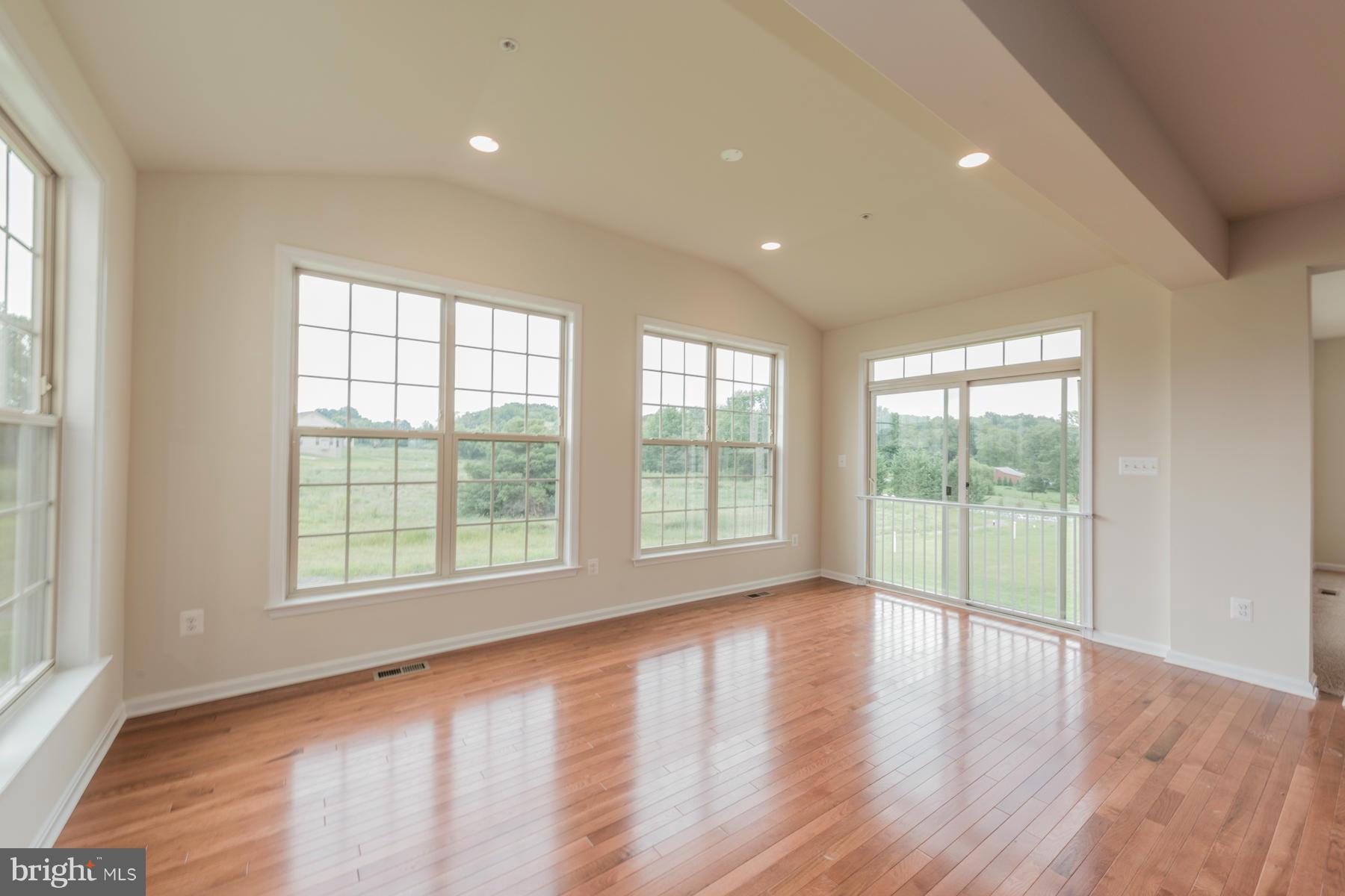 4336 Chapel Road Perry Hall, MD 21128 - Photo 10 of 30 a view of an empty room with wooden floor and a window