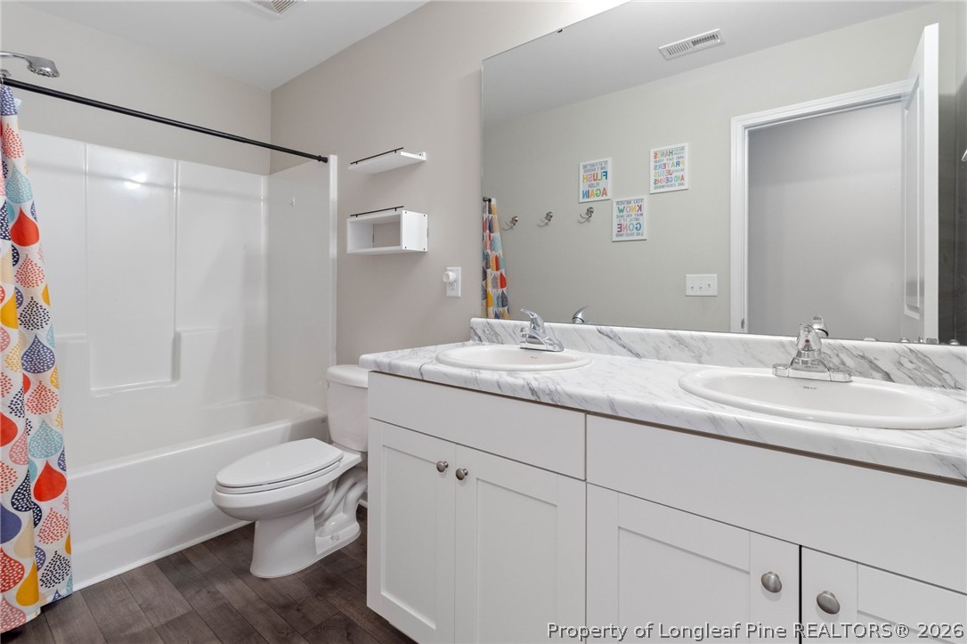 1368 Talmage Road St. Pauls, NC 28384 - Photo 19 of 26 a bathroom with a granite countertop sink toilet and shower
