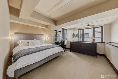 a bedroom with a bed and a night stand