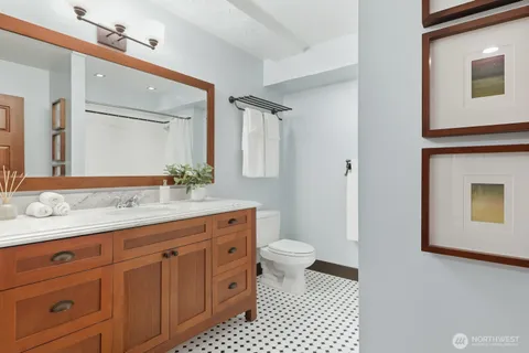 a bathroom with a sink a toilet and a mirror