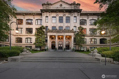 a front view of a residential apartment building with a yard