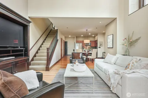 a living room with furniture and a wooden floor