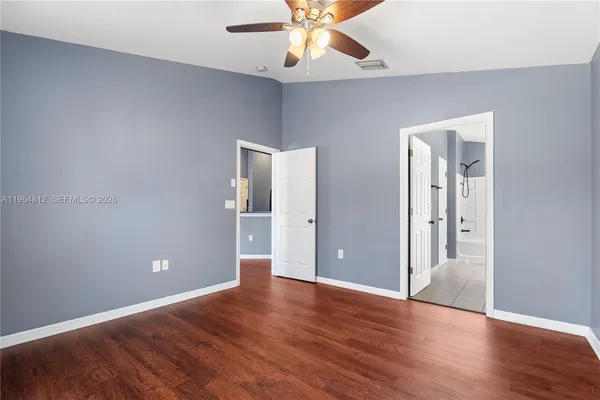 a view of an empty room with wooden floor