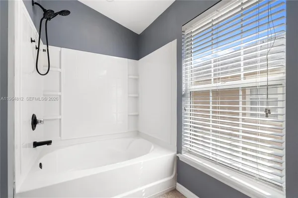 a bathroom with a bath tub and a shower