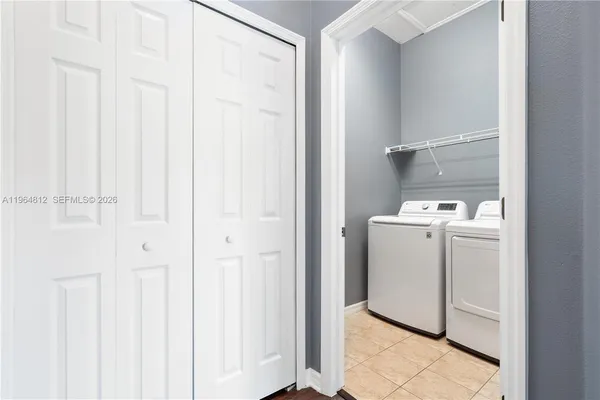 a utility room with cabinets washer and dryer