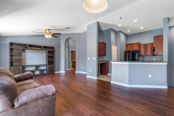 a living room with furniture and kitchen view