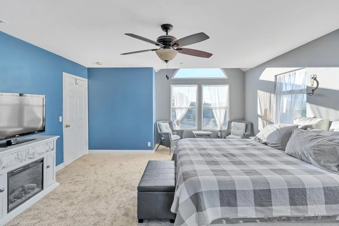 1880 Keyes Road Ramona, CA 92065 - Photo 20 of 49 a spacious bedroom with a bed and a flat screen tv