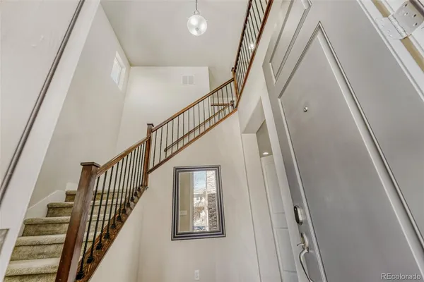 a view of staircase with wooden floor and white walls