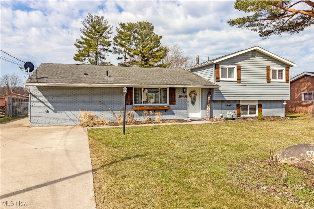 5900 Lear Nagle Road North Ridgeville, OH 44039 - Photo 35 of 35 Split level home with brick siding, concrete driveway, a front yard, and a shingled roof