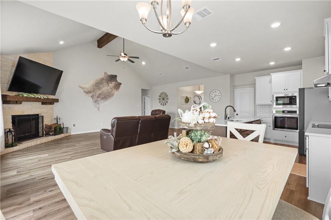 596 J W Martine Road Hearne, TX 77859 - Photo 13 of 36 a view of a dining room with furniture a fireplace and wooden floor