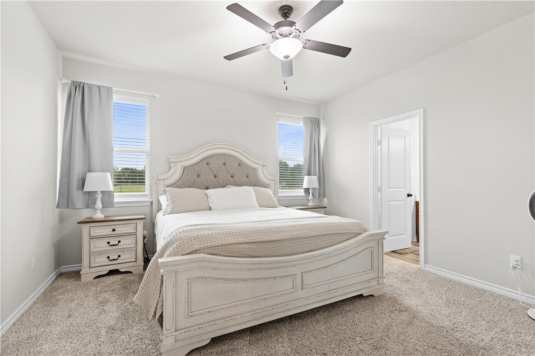 596 J W Martine Road Hearne, TX 77859 - Photo 15 of 36 a bedroom with a bed and a chandelier