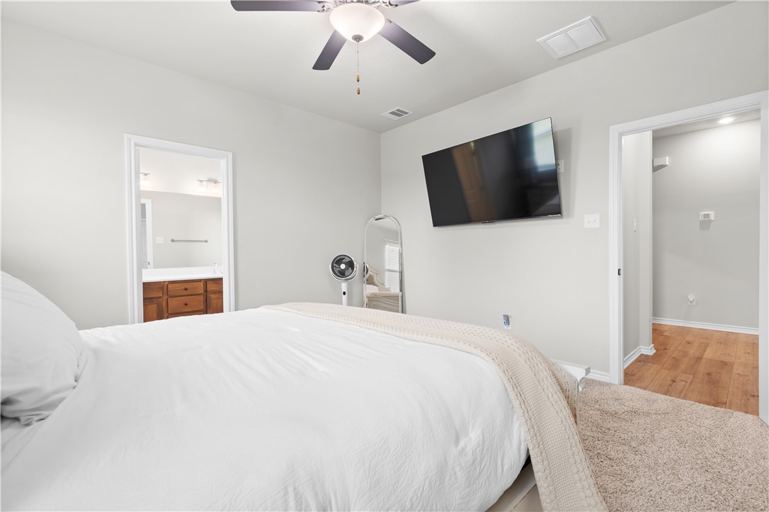 596 J W Martine Road Hearne, TX 77859 - Photo 16 of 36 a bedroom with a bed and a flat screen tv