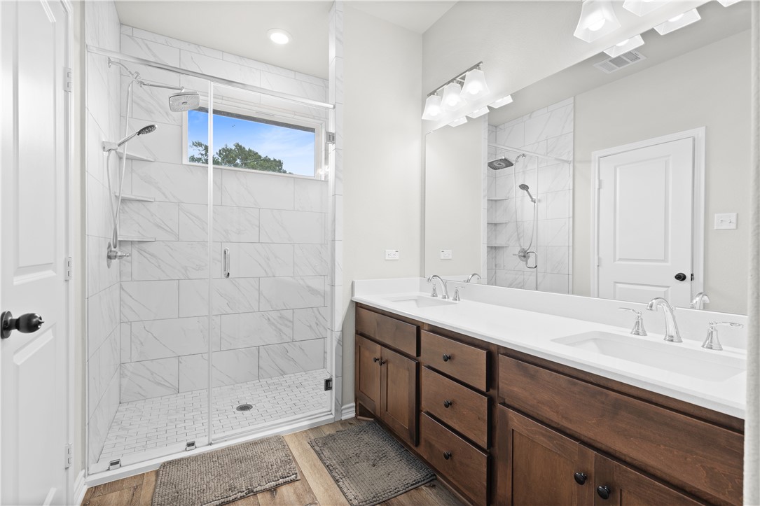 596 J W Martine Road Hearne, TX 77859 - Photo 18 of 36 a bathroom with a shower sink double and mirror
