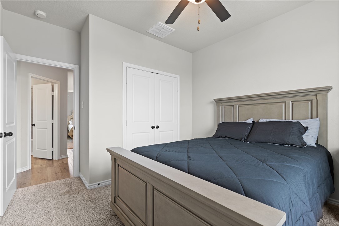 596 J W Martine Road Hearne, TX 77859 - Photo 20 of 36 a bedroom with a bed and a chandelier