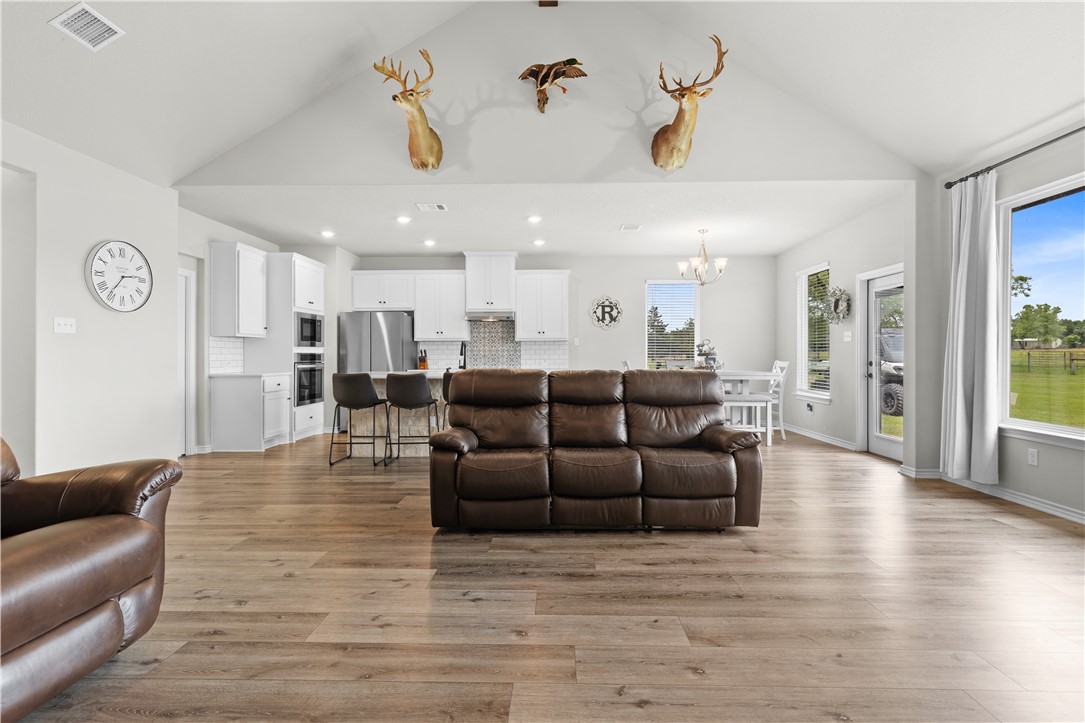 596 J W Martine Road Hearne, TX 77859 - Photo 2 of 36 a living room with furniture wooden floor and a large mirror