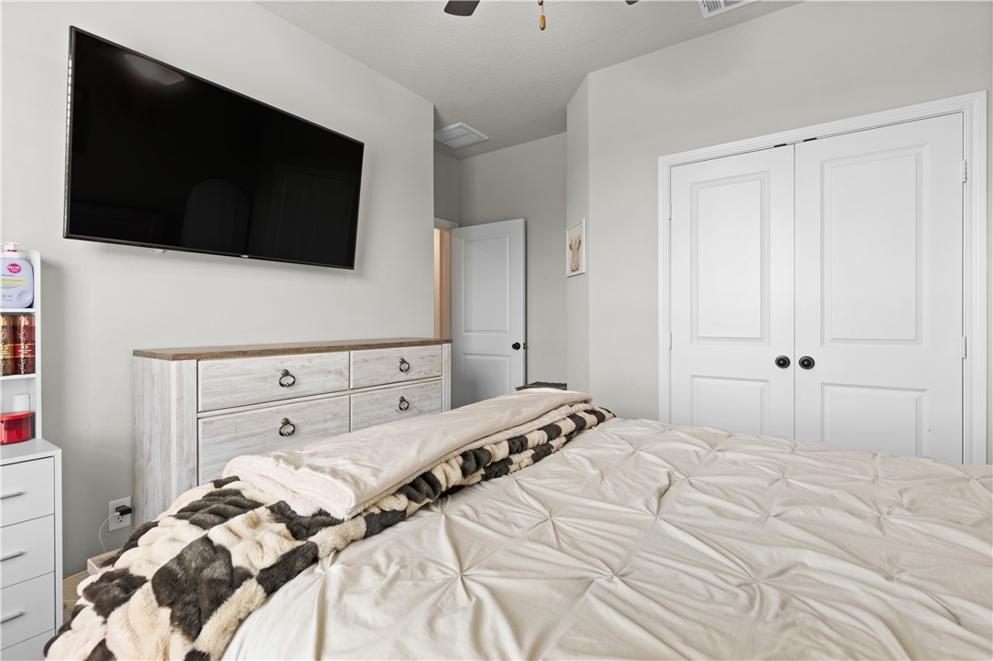 596 J W Martine Road Hearne, TX 77859 - Photo 23 of 36 a bedroom with a bed and a flat tv screen in it