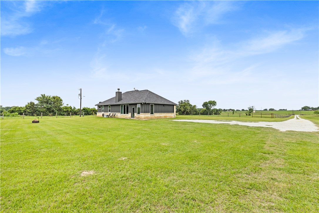 596 J W Martine Road Hearne, TX 77859 - Photo 29 of 36 a view of a lake with a big yard