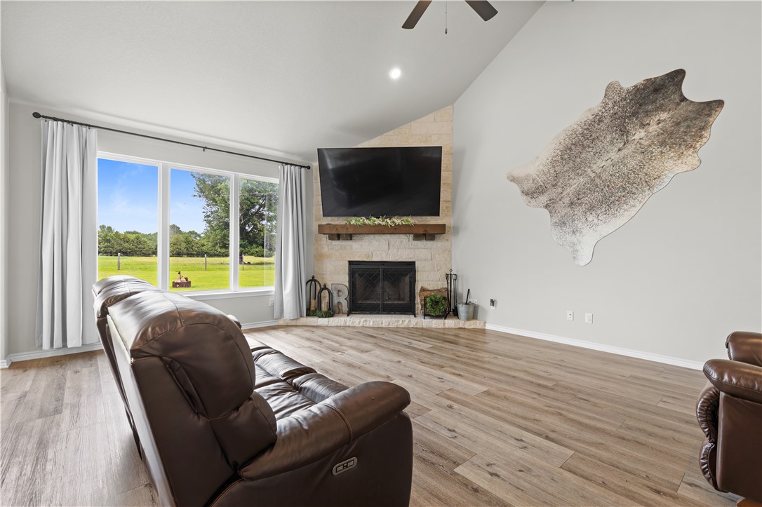 596 J W Martine Road Hearne, TX 77859 - Photo 4 of 36 a living room with furniture a flat screen tv and a fireplace