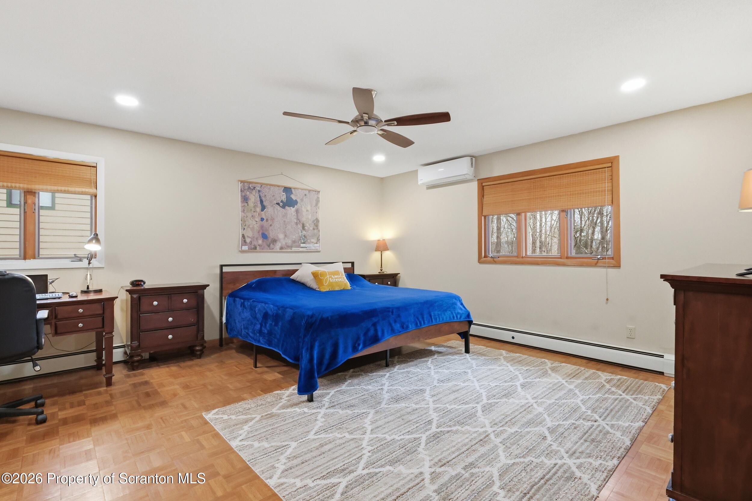 1647 Windmere Place Lake Ariel, PA 18436 - Photo 15 of 65 a bedroom with a large bed and a chandelier