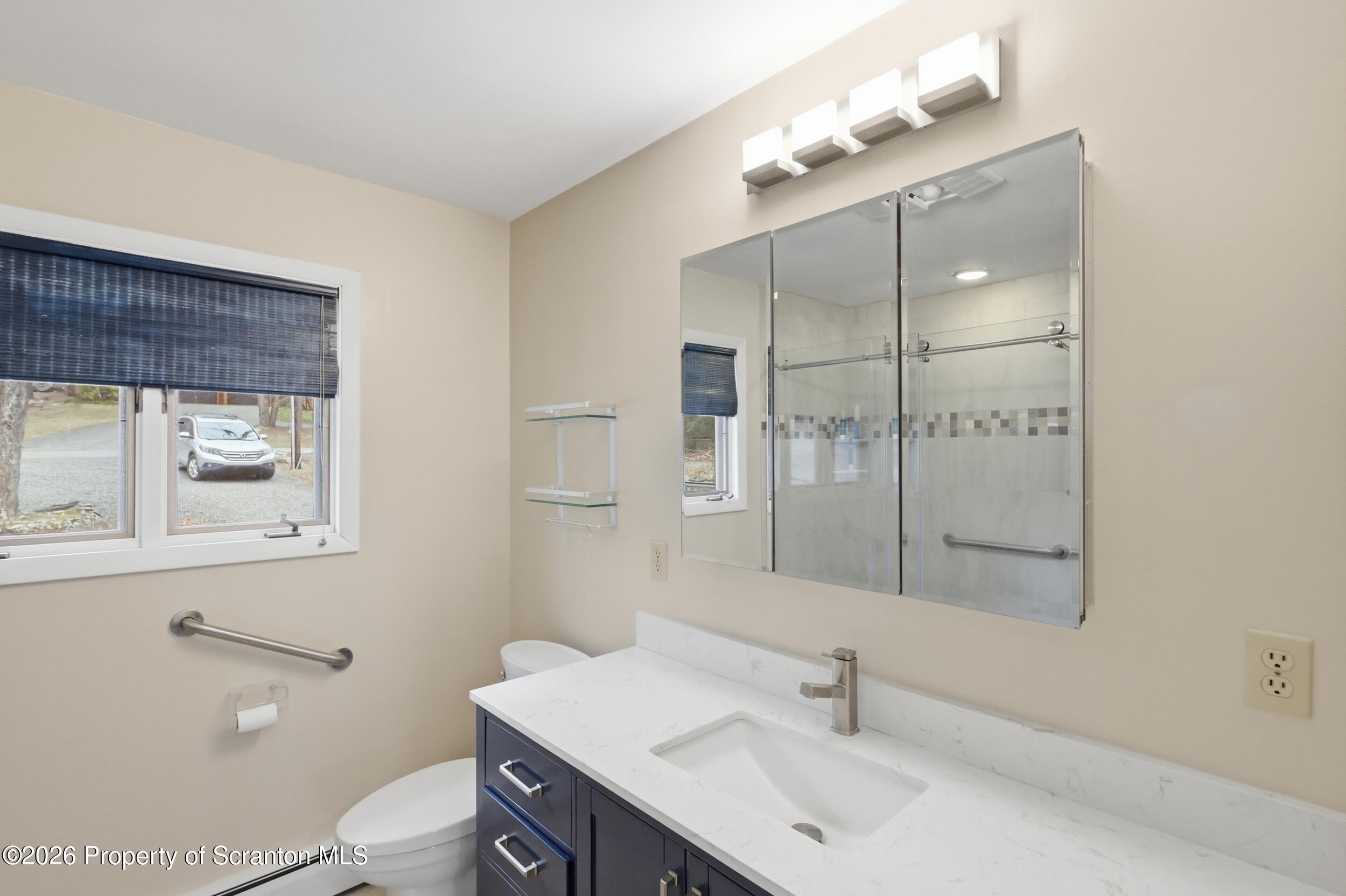 1647 Windmere Place Lake Ariel, PA 18436 - Photo 18 of 65 a bathroom with a sink toilet and shower