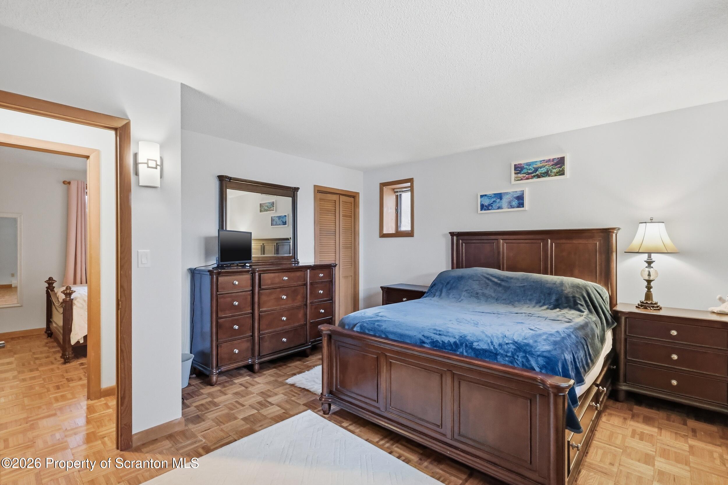 1647 Windmere Place Lake Ariel, PA 18436 - Photo 21 of 65 a bedroom with a bed and a dresser in it