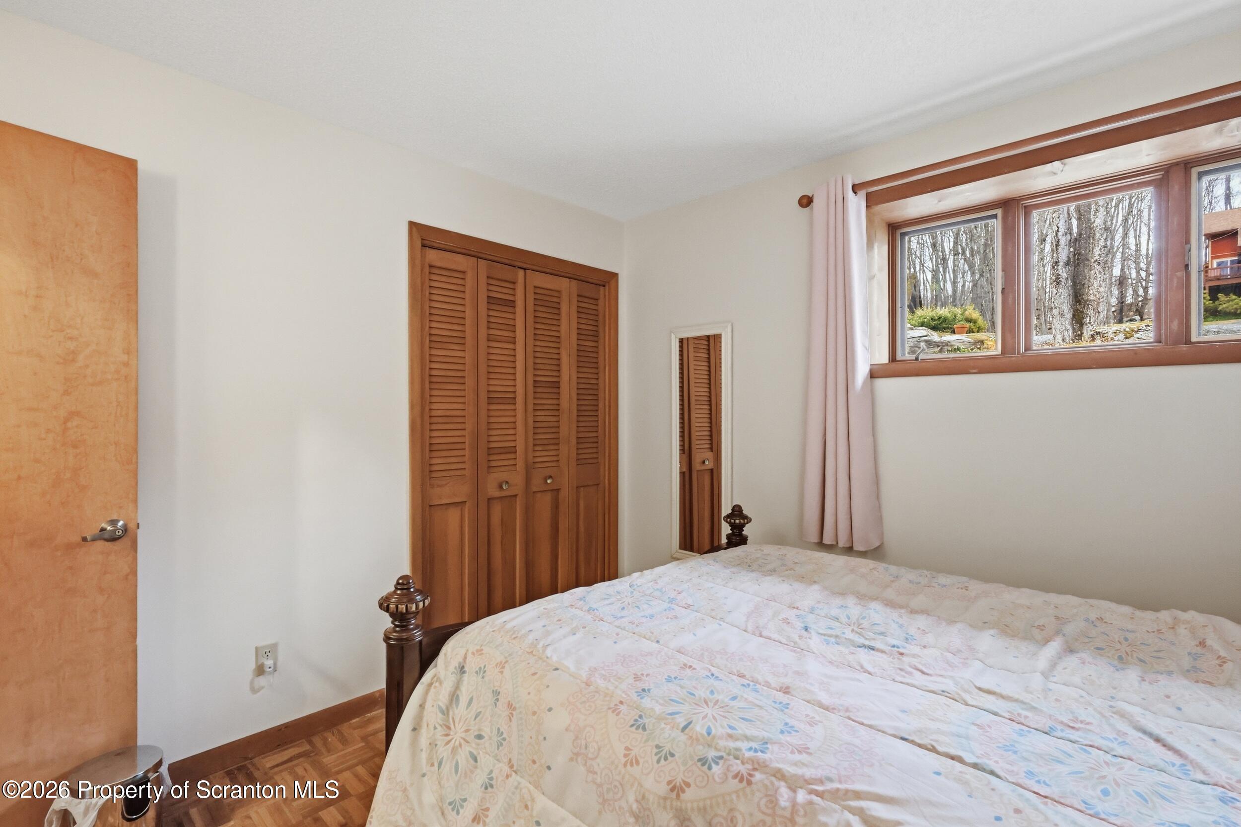 1647 Windmere Place Lake Ariel, PA 18436 - Photo 25 of 65 a bedroom with a bed and a window