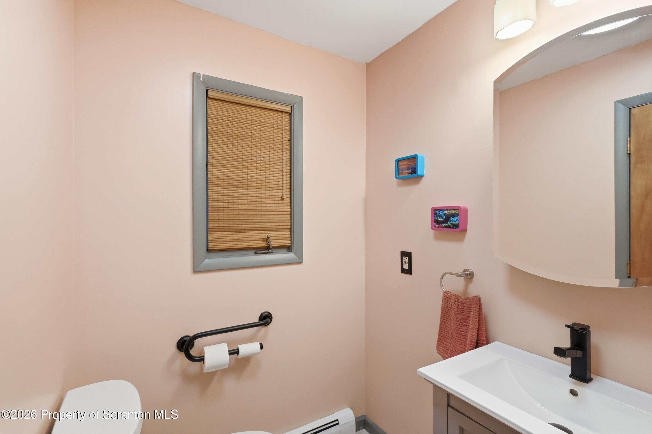 1647 Windmere Place Lake Ariel, PA 18436 - Photo 26 of 65 a bathroom with a sink and a mirror