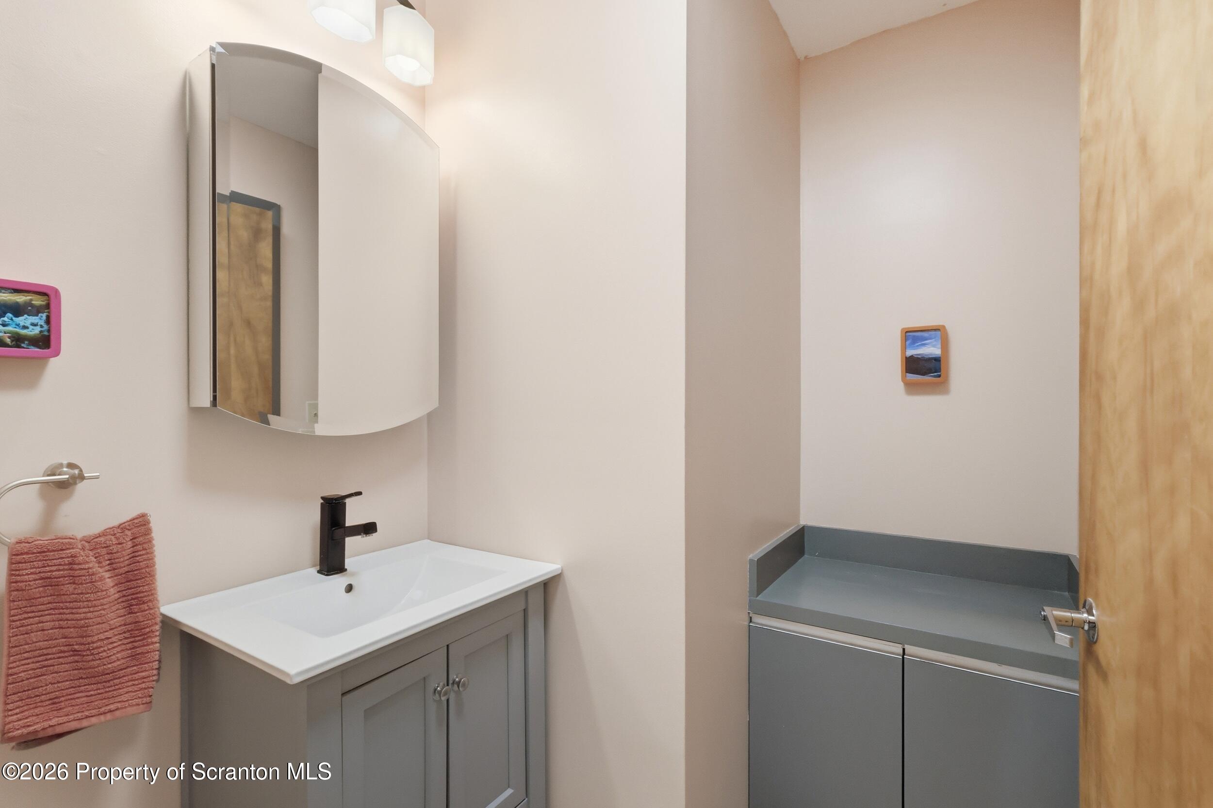 1647 Windmere Place Lake Ariel, PA 18436 - Photo 27 of 65 a bathroom with a sink and a mirror