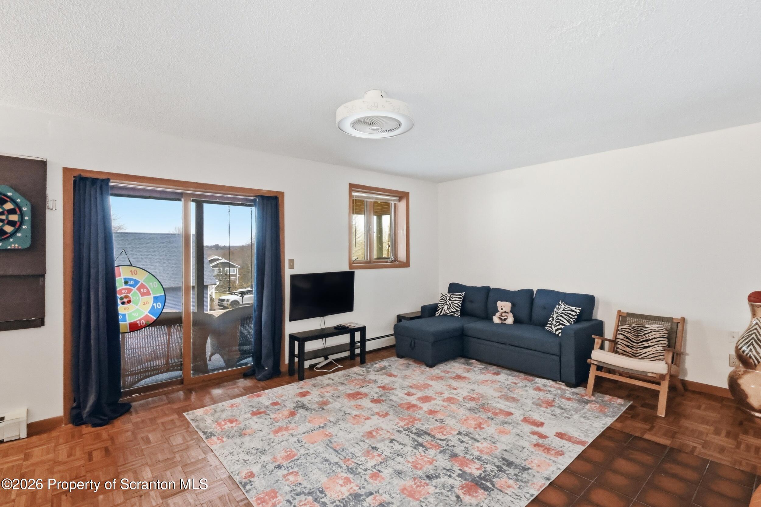 1647 Windmere Place Lake Ariel, PA 18436 - Photo 28 of 65 a living room with furniture window and a flat screen tv