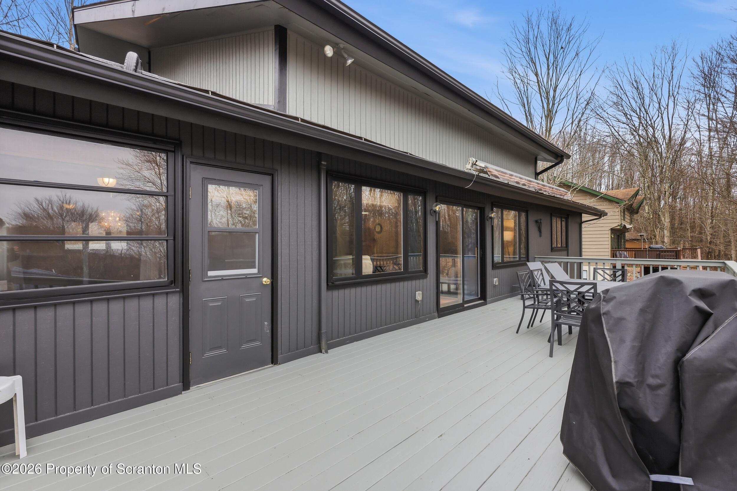 1647 Windmere Place Lake Ariel, PA 18436 - Photo 36 of 65 a view of a patio with table and chairs and couches with wooden floor