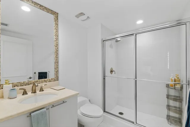 a bathroom with a toilet sink and shower