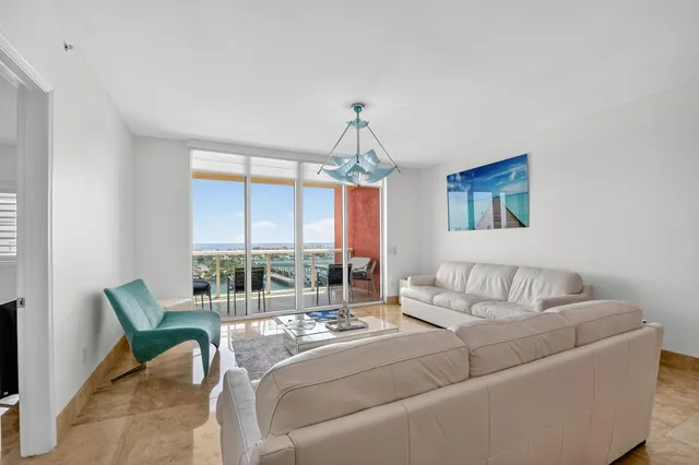 a bedroom with furniture and a large window