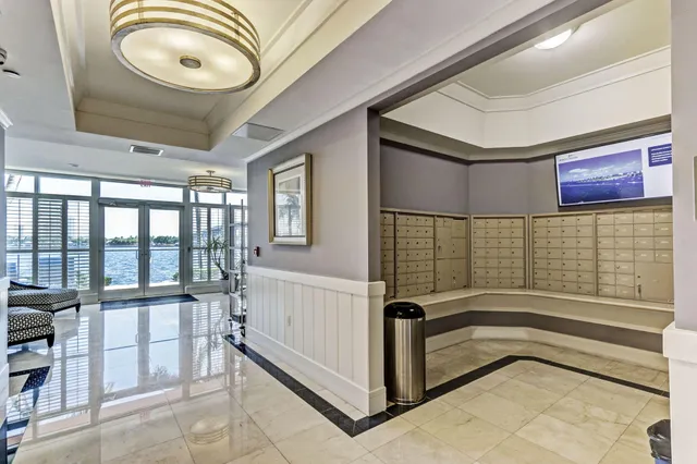 a view of a swimming pool with a bench and trees in the background