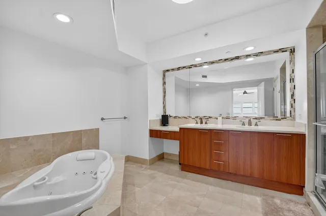a bathroom with a shower sink vanity mirror and toilet