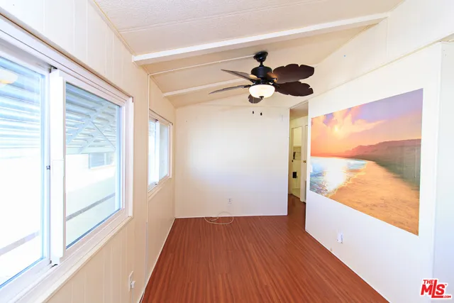a view of an empty room and wooden floor