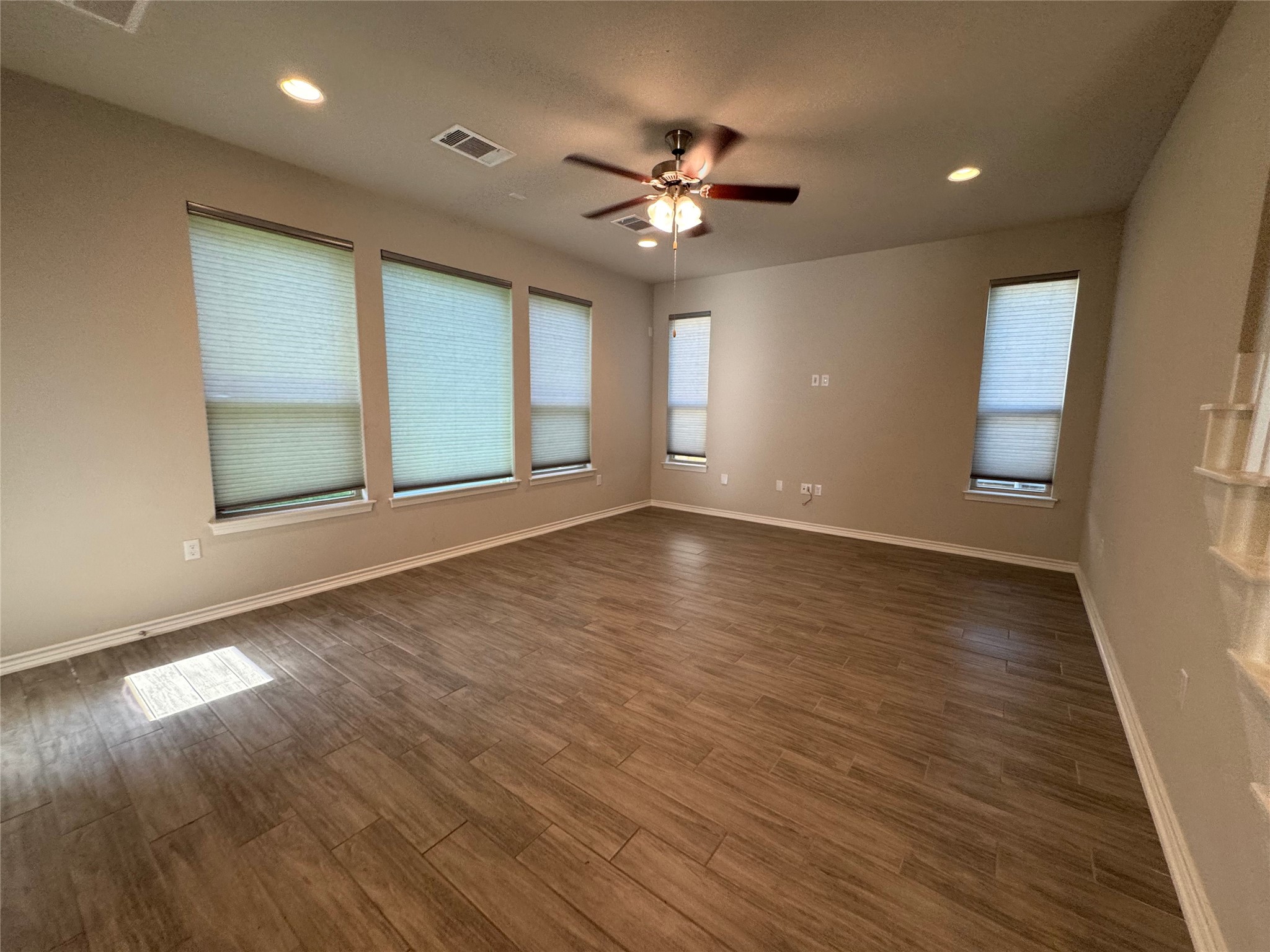 14100 McCoy Loop, Unit 1 Austin, TX 78717 - Photo 10 of 39 A spacious living area with warm wood-look flooring awaits new memories.